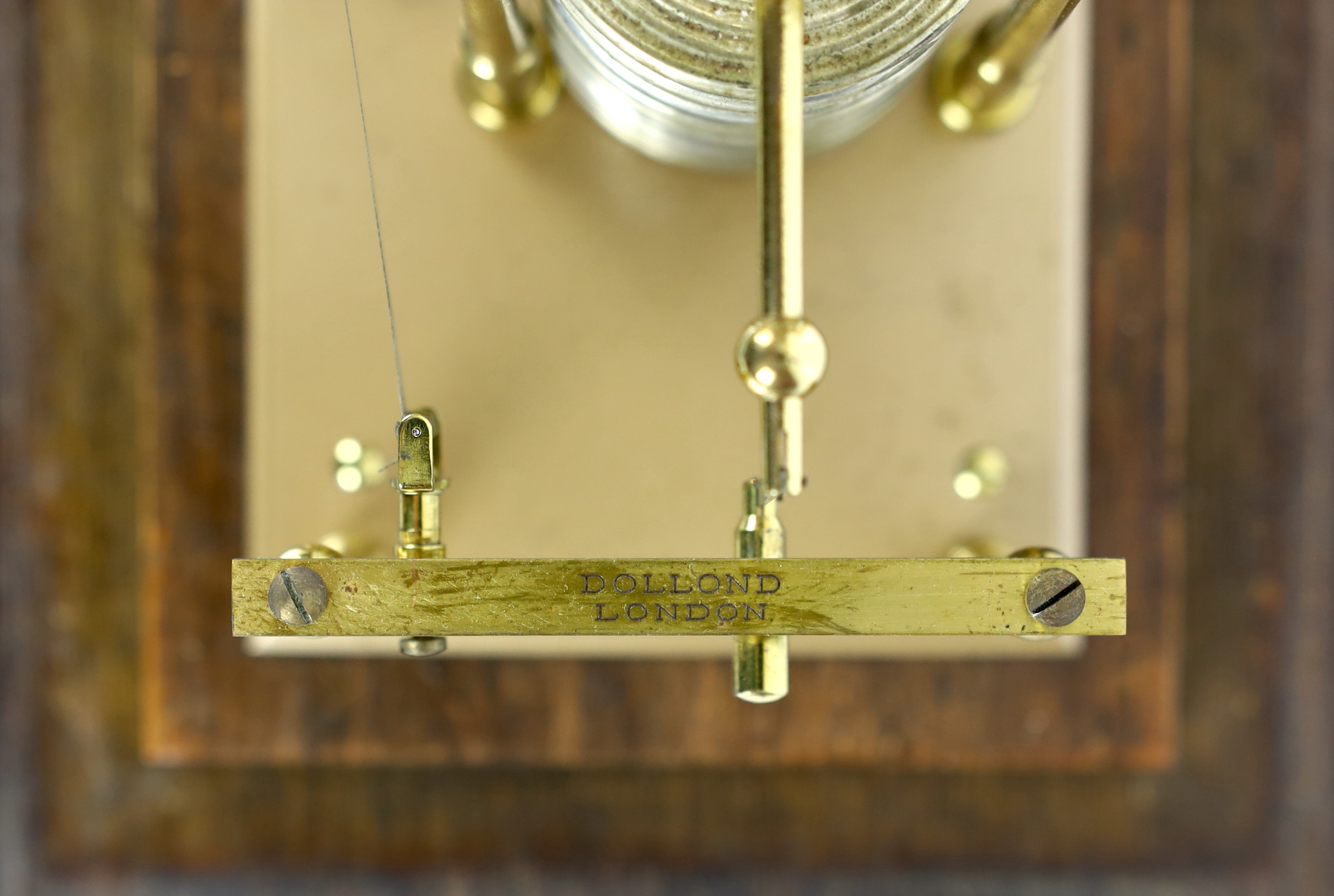A barograph by Dollond in an oak case with bevelled glass panels and incorporating an ink bottle and a drawer with spare graph papers, 36.5cm x 21.5cm